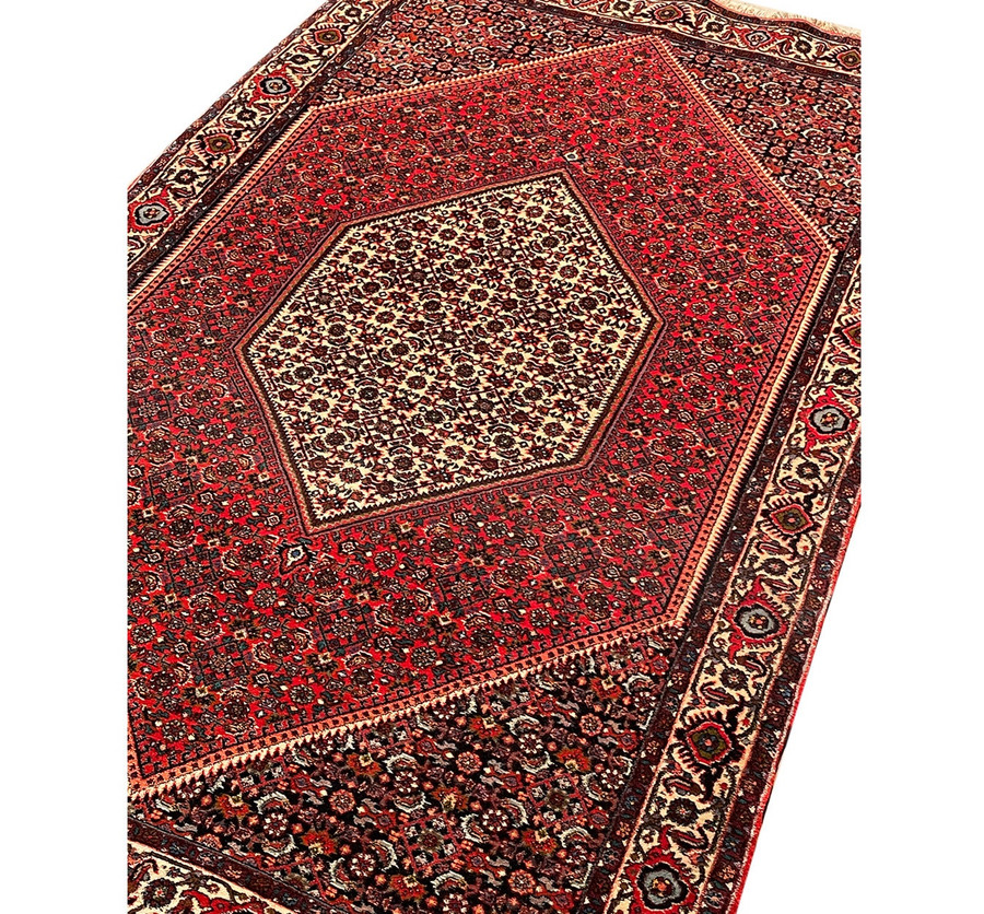 Angled full view of the Persian Bijar rug, emphasizing the texture and craftsmanship of the wool weaving.