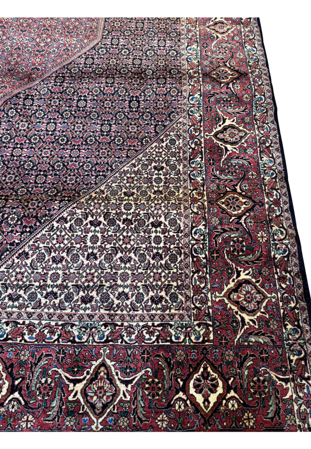 The dense weave and complex design of the Persian Bijar rug's field, with a focus on the multitude of small, detailed floral and geometric figures