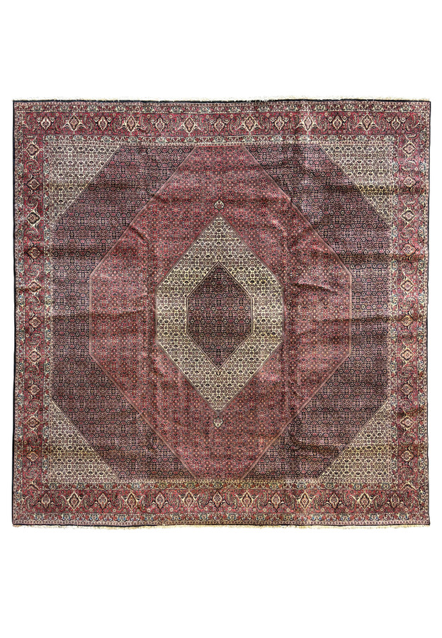 Full view of a grand 13 x 13 Persian Bijar square rug laid out to showcase its rare size and detailed geometric and floral designs in deep reds and blues