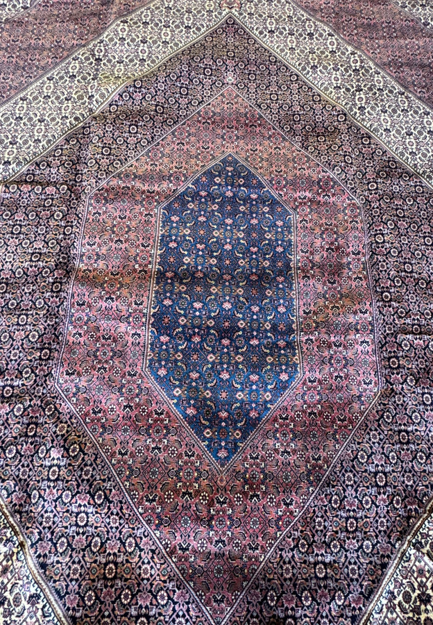 Dive into the world of Persian artistry with this Bijar rug, where the central medallion takes center stage, surrounded by a tapestry of symbols and detailed patterns woven into every inch of the rug