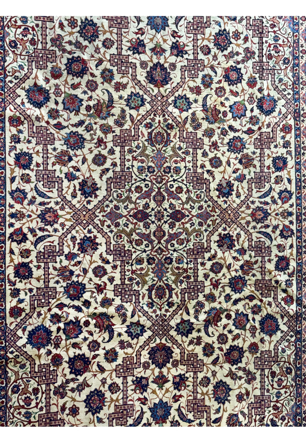 Close-up of the rug's central field, highlighting the intricate patterns and the contrast between the wool and silk.