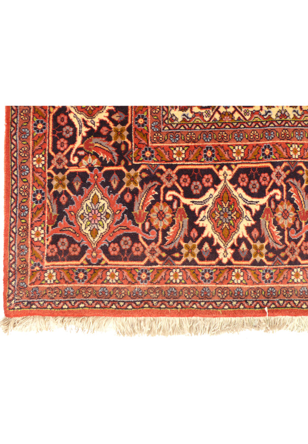 A detailed section of the Bijar rug, focusing on the intricate border design with its array of floral motifs and contrasting color palette that frames the central field.