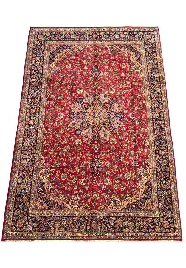 Detailed view of Persian Isfahan rug craftsmanship - Close-up image focusing on the detailed craftsmanship of the Persian Isfahan rug, highlighting the intricate floral designs and color contrasts.