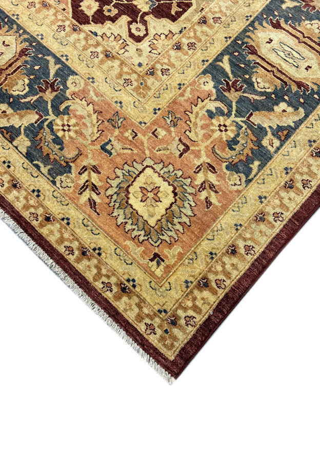 Detailed close-up of a 12' x 15' Agra rug corner, showcasing the intricate classical motifs and the high-quality natural wool texture. The vibrant vegetable-dyed colors highlight the craftsmanship of the handwoven rug.