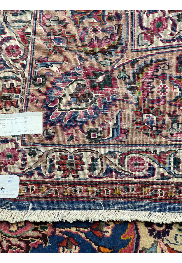 Back view of a Persian Mashad Rug, showing the detailed craftsmanship and weaving techniques used in its creation.
