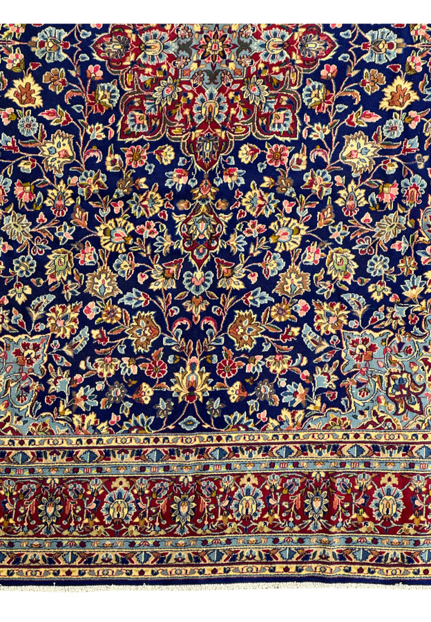 Detailed view of the lower border on a Persian Kerman Rug, highlighting the complementary floral motifs and the precise craftsmanshi