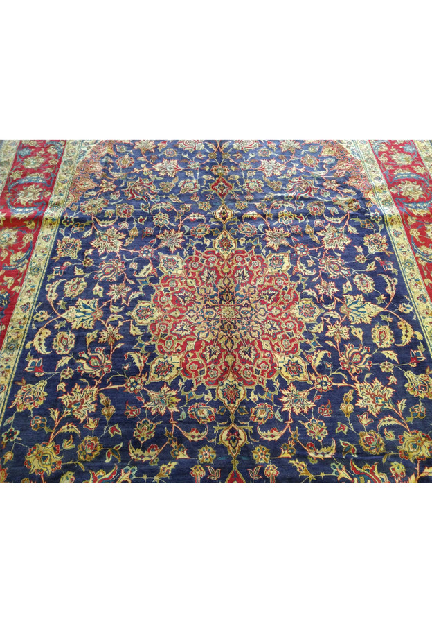 Close-up view of the 10'6 x 15'8 Persian Najafabad Rug, showcasing the detailed floral motifs and central medallion design. The rich navy blue background is complemented by vibrant red, gold, and ivory accents, exemplifying fine Persian craftsmanship