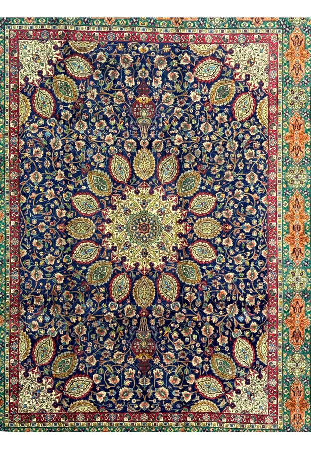 Full view of a 10'5 x 13 Persian Tabriz Rug, showcasing the complete design. The rug features a central medallion with complex floral patterns radiating outward, set against a deep navy blue background. The borders are richly decorated with intricate motifs in red, green, and gold, framed by a wider border of geometric and floral designs in complementary colors. The high knot density and quality wool ensure both durability and a luxurious feel.