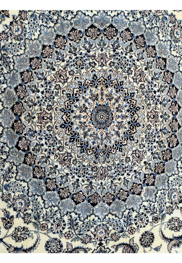 Close-up of the corner and border patterns on a 13 x 20 Persian Nain 9LAA Wool & Silk Rug
