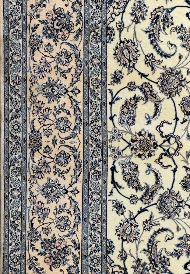Close-up of the intricate weaving on the border of a 13 x 20 Persian Nain 9LAA Wool & Silk Rug