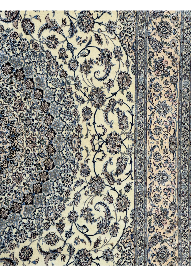 Detailed view of the central medallion and floral motifs of a Persian Nain 9LAA Wool & Silk Rug.