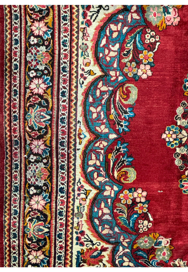 Close-up of the border on a 11x13 Persian Mahal rug showing floral and vine patterns.
