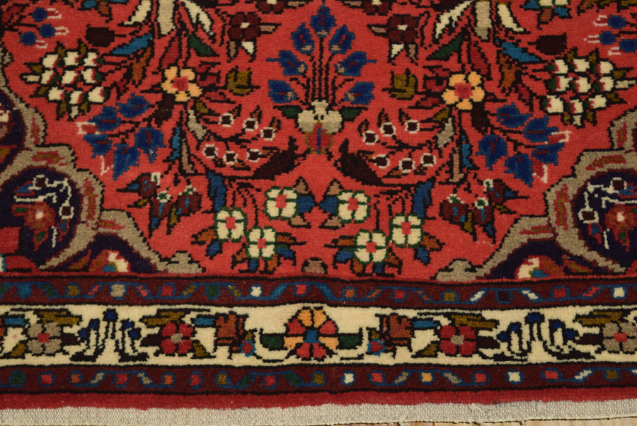 Border of a 3x10 Rudbar Persian Rug intricating ivory border, dark Pink central field and floral motifs