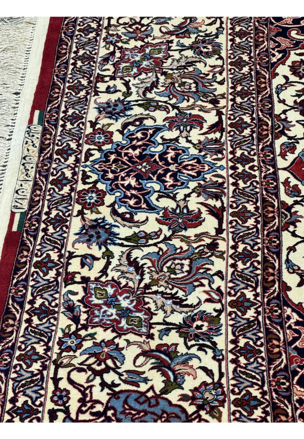 Close-up of border floral motifs and signature of Seirafian on Persian Isfahan Silk Rug.