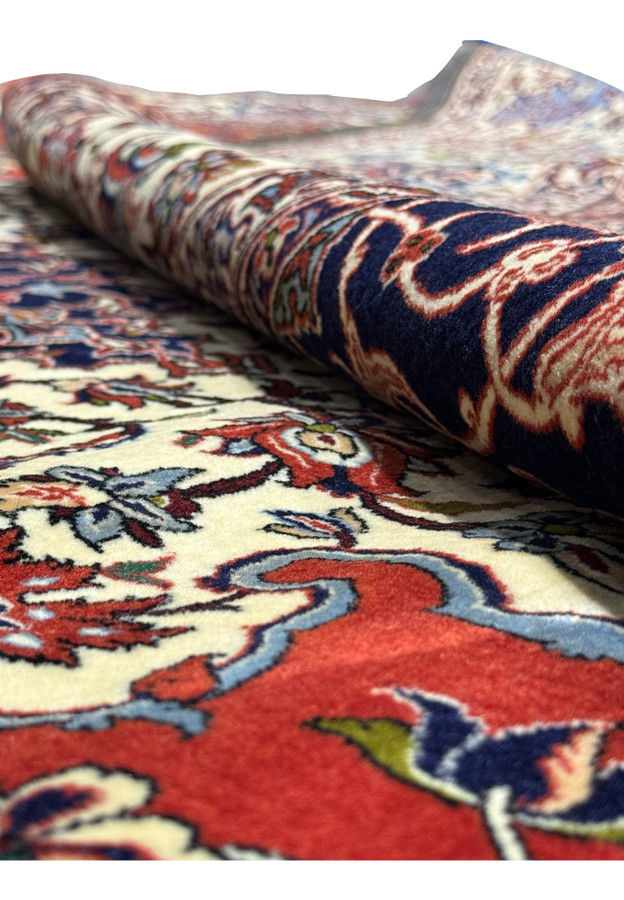 Rolled view highlighting the detailed floral patterns in Persian Isfahan Silk Rug.