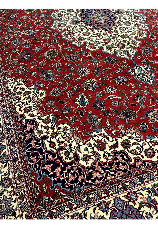 Close-up of floral motifs and vibrant red background in Persian Isfahan Silk Rug.