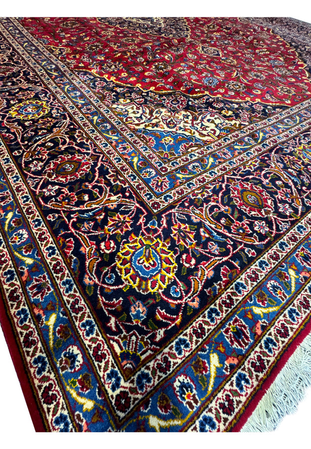 Close-up view of the corner of the Persian Kashan Rug, showcasing the fine details and color contrasts.