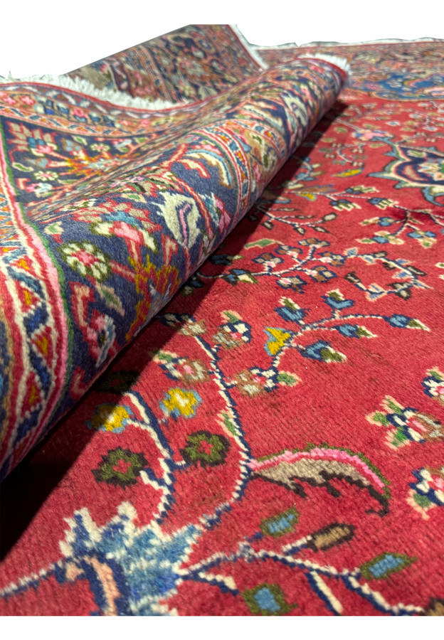 Close-up of the border of the 10x12 Persian Mashad rug, featuring floral and vine motifs.