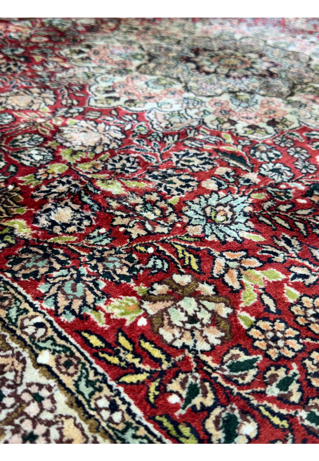 A close-up of the central medallion of the 5 x 8 Oriental Kashmir Silk Rug, emphasizing the complex design and vibrant color palette.