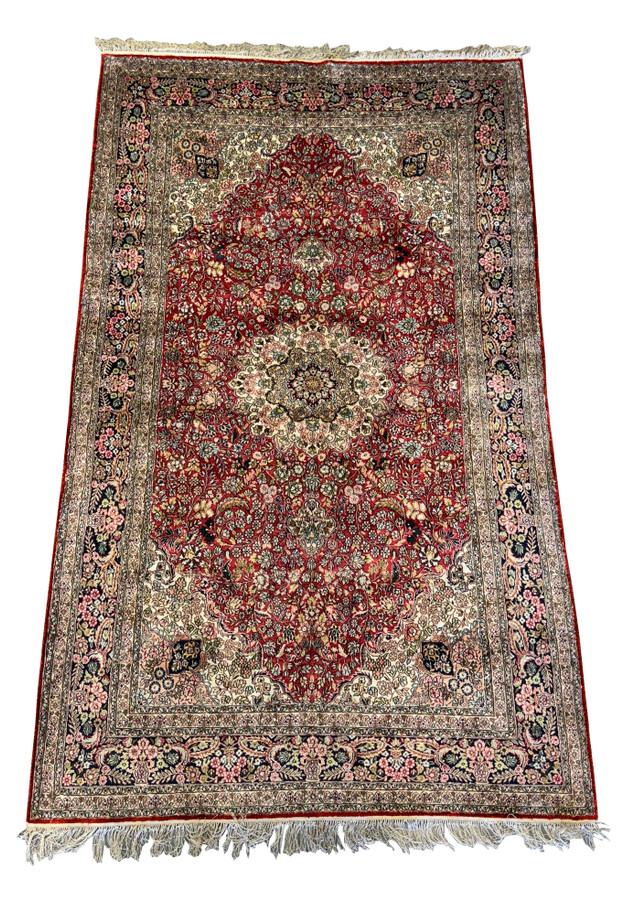 The entire 5 x 8 Oriental Kashmir Silk Rug laid flat, highlighting the rich red field and intricate border designs in various colors.