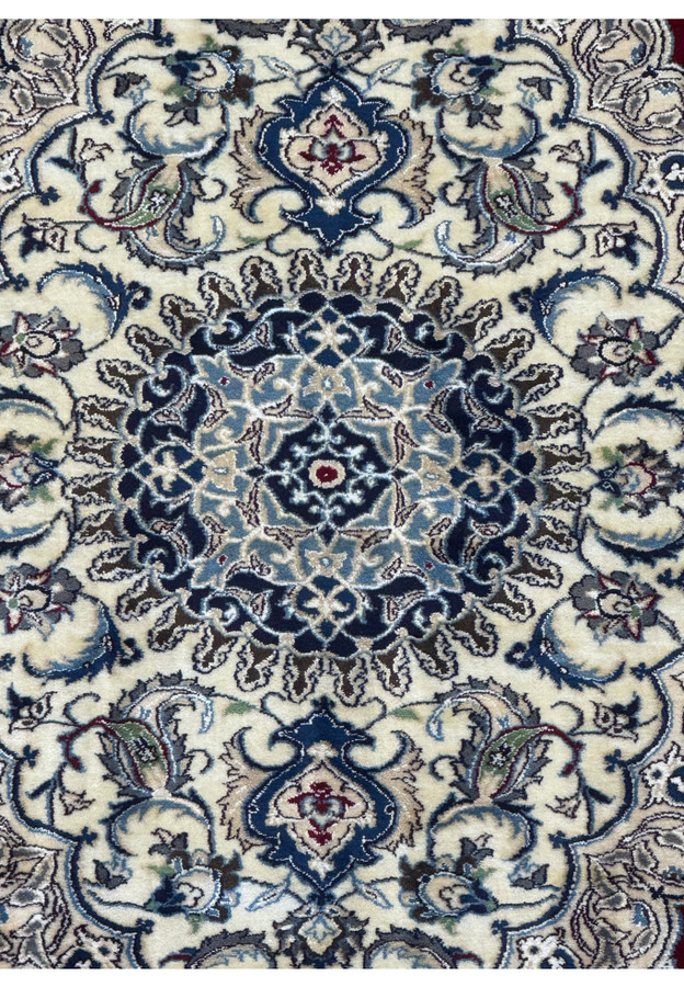 Zoomed-in view of the medallion on the 6'8 x 10'4 Persian Nain 9LAA Wool & Silk Rug, showcasing the intricate design and color details