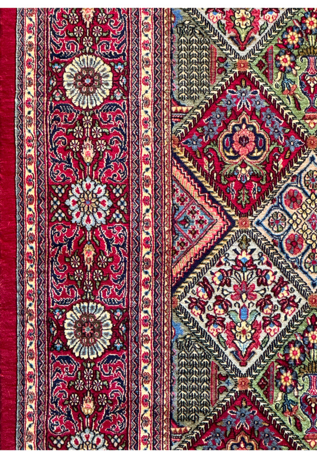 Detailed view of a section of the Persian Qum rug, highlighting the variety of colors and motifs used in the design