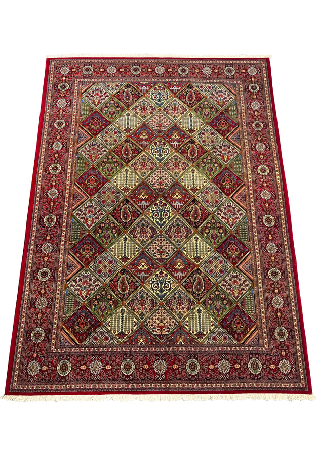 Top view of a 6'8 x 10 Persian Qum rug, highlighting its vibrant red background and detailed diamond-shaped medallions