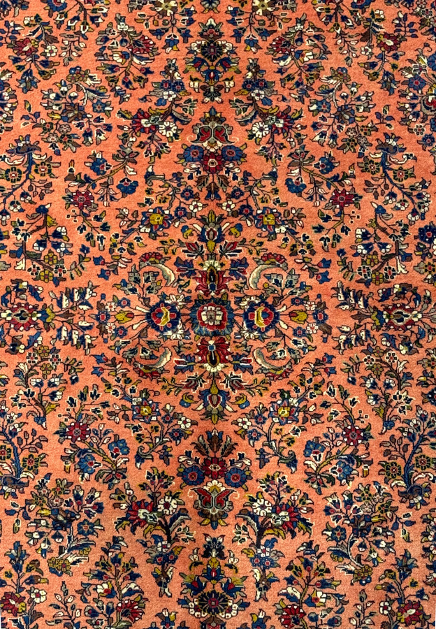 Close-up of the central medallion on the 5'6" x 8'5" Persian Sarouk rug.