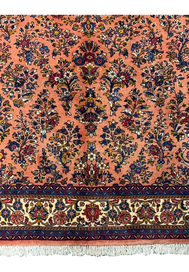 Lower section of the 5'6" x 8'5" Persian Sarouk rug with detailed border design.