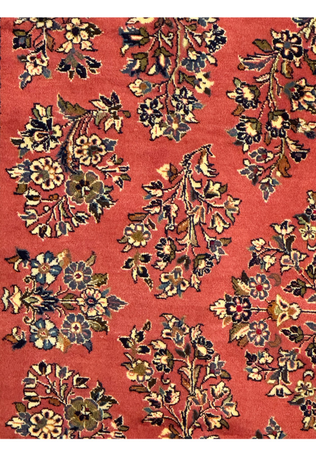 6'9 x 9'8 Persian Yazd rug displaying vibrant red field and symmetrical floral designs.