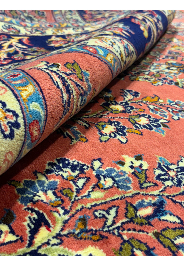 Detailed craftsmanship of floral motifs on Persian Yazd rug, highlighting natural dye colors.