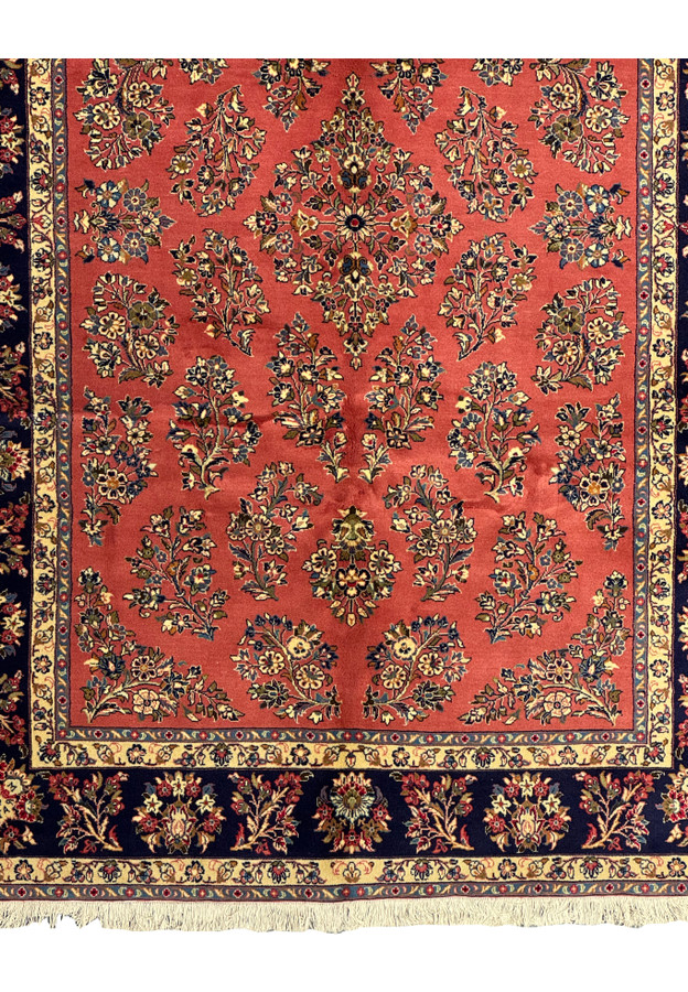 Close-up of the fringe on a Persian Yazd rug, demonstrating fine craftsmanship.