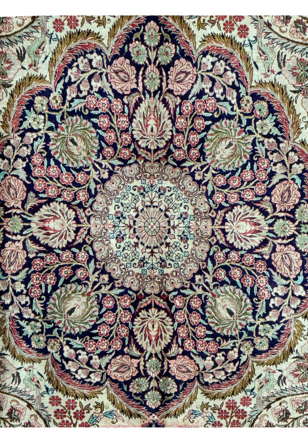 Central medallion of a Persian Tabriz 100% silk rug with intricate floral patterns