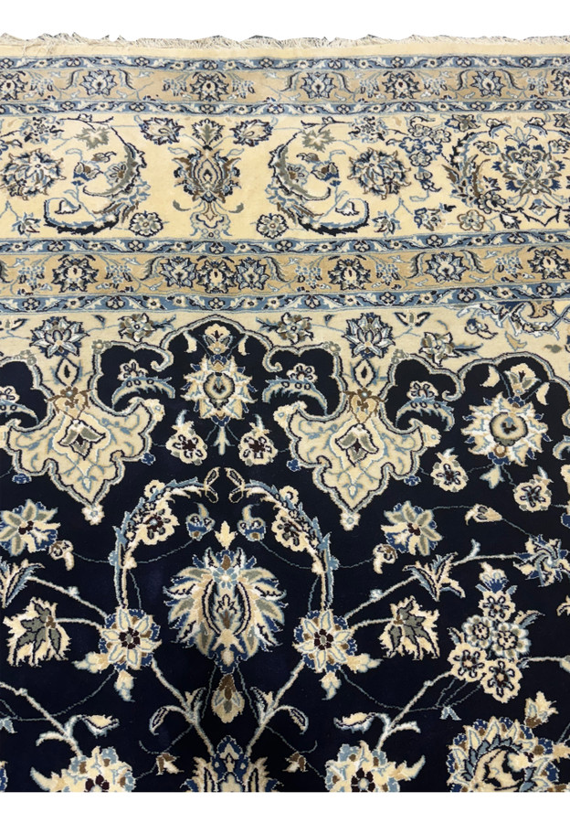 Upper border of this 13x19'8 Persian Nain 9LA Rug with dominantly ivory and navy blue colors