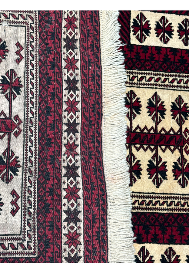 Reverse side of a 3'6 x 5'4 Persian Baluch Rug with visible craftsmanship and label.