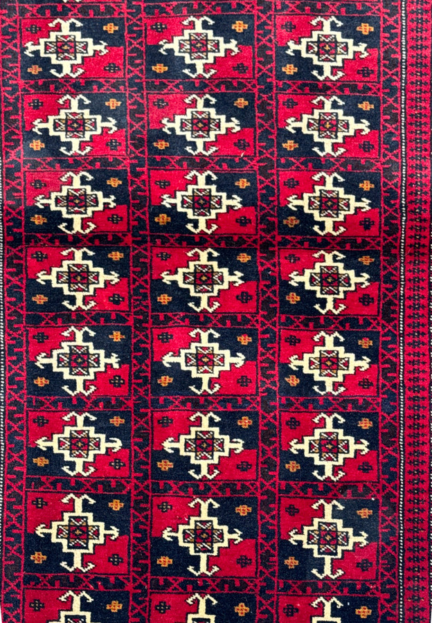 Close-up of geometric motifs on 3'6 x 4'9 Persian Baluch Rug.