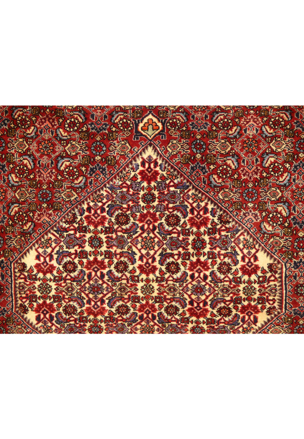Close-up of the 5'5 x 10 Persian Bijar Rug's central medallion and surrounding floral patterns in rich crimson and navy blue