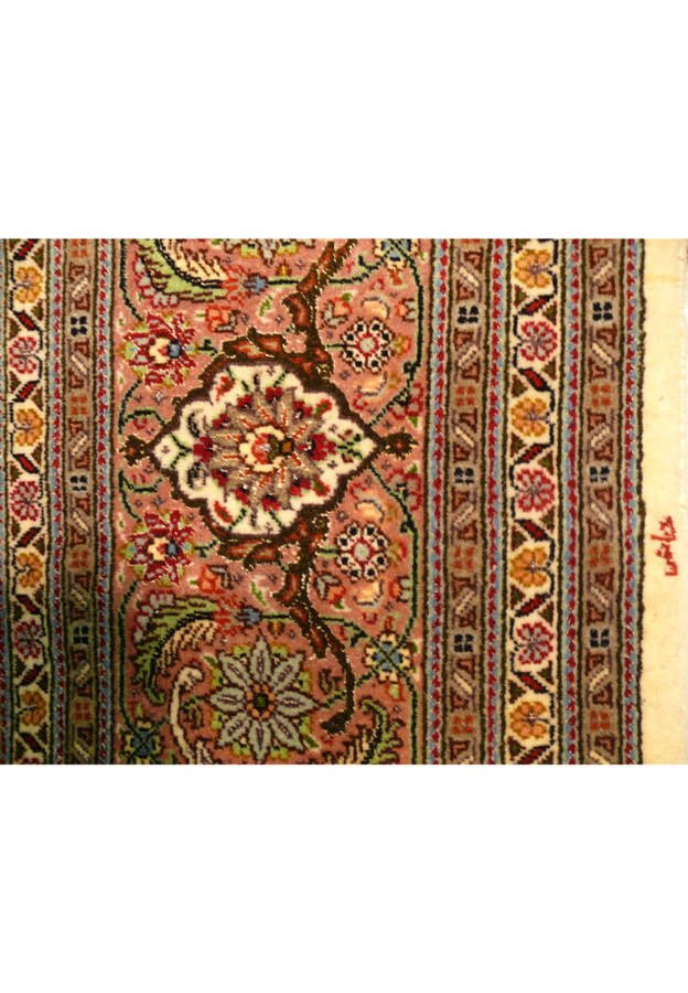 Right edge of the Tabriz Mahi Silk Rug featuring the signature of the master weaver.