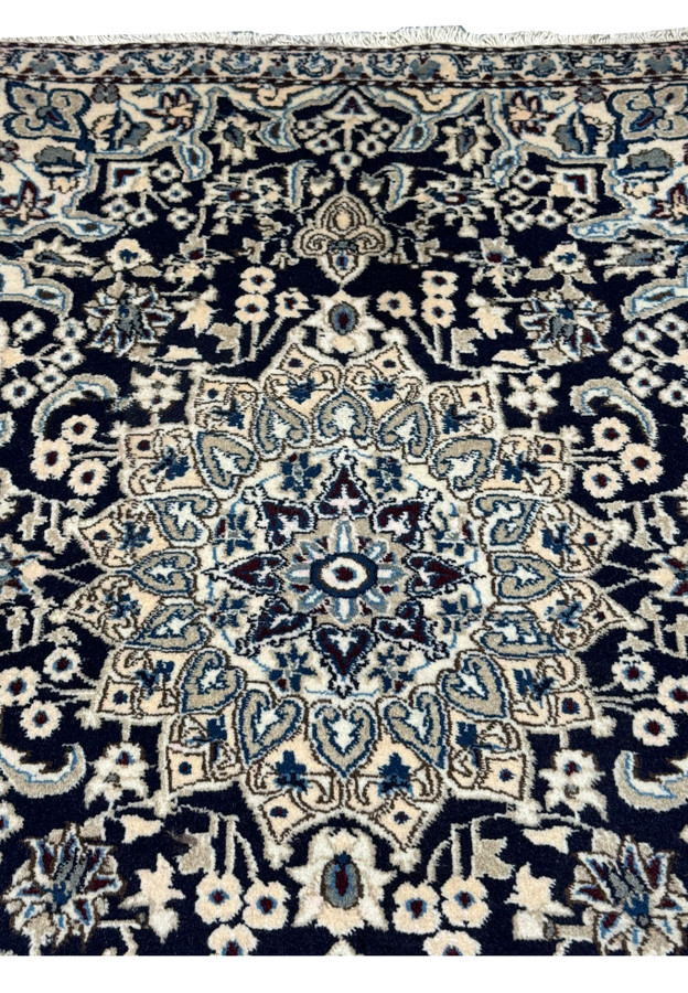 Midfield section of the 3x5 Persian Nain rug displaying floral motifs.