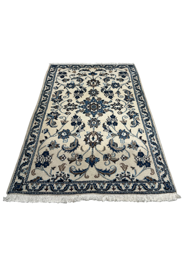 Angled view of a Persian Nain Rug displaying the intricate designs and luxurious texture.
