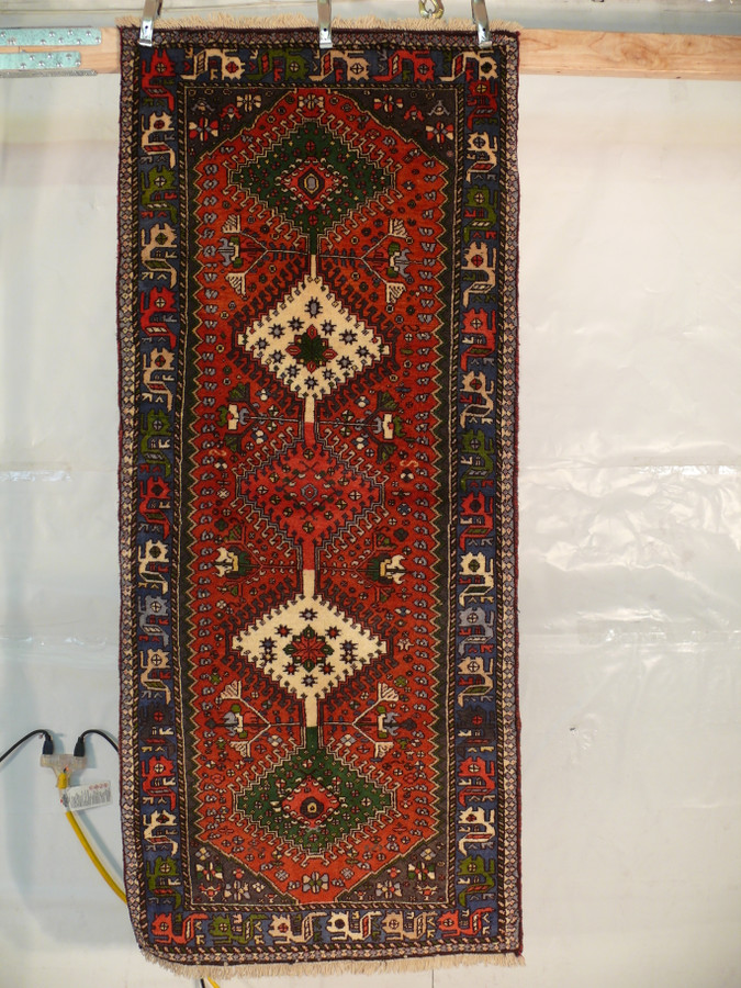 Hanging view of a 2'8 x 6'3 Persian Yalameh Runner to highlight its vertical design.