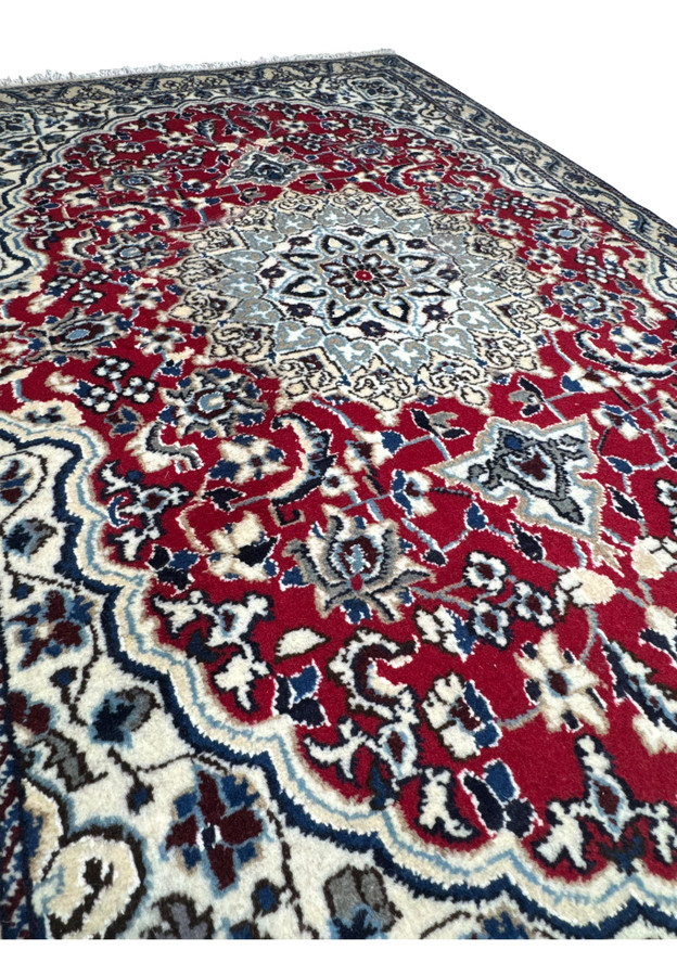 Side view of the 3 x 4.6 Red Nain Persian Rug displaying its thickness and pattern continuity.