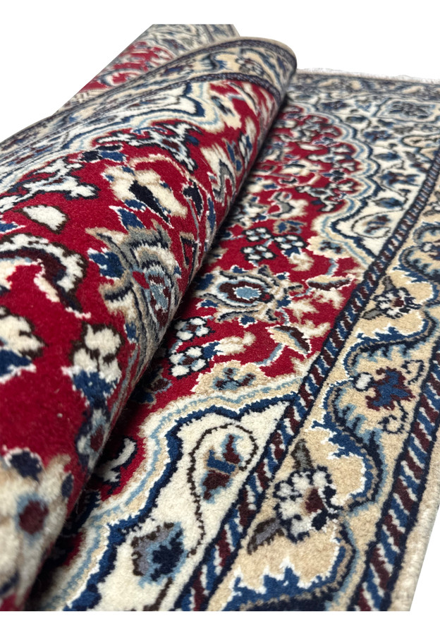 Rolled view of the 3 x 4.6 Red Nain Persian Rug highlighting the texture and detailed pattern.