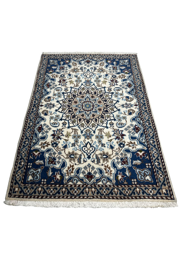 3 x 4'6 Nain Persian Rug laid down, showing the detailed floral patterns and medallion design on a cream background.