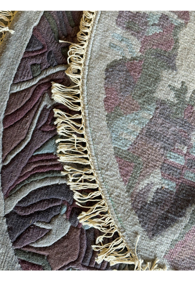 Backside view of the Nepal round rug, revealing the foundation and knotting technique with fringed edges.