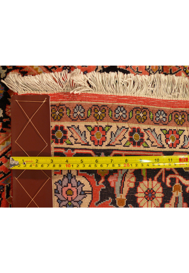 Close-up of the 8'2 x 11'4 Persian Bijar Rug's backside, highlighting the density and high quality of the weave with a measuring tape for scale.