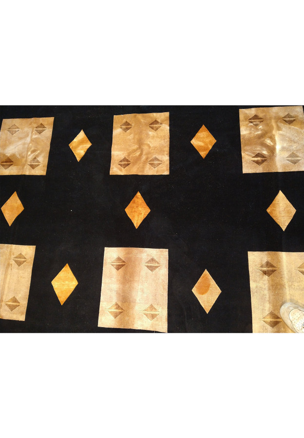 Pattern detail of 8'9 x 11'10 contemporary rug featuring golden geometric shapes.