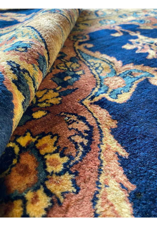 Detailed view of the Persian Kerman Lavar rug's edge, showcasing handwoven quality