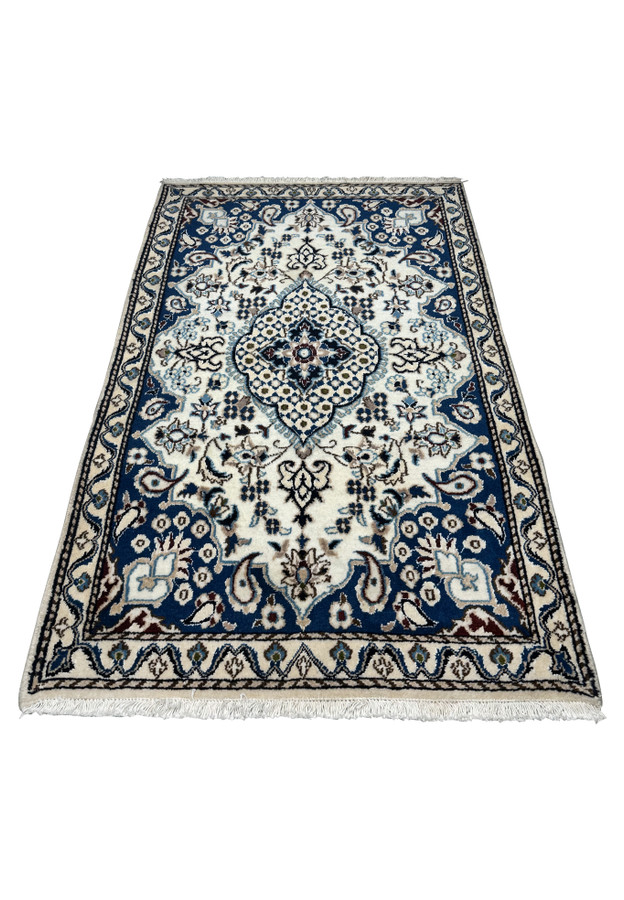 Laid down view of 3x4'10" Persian Nain Rug with ivory and blue details