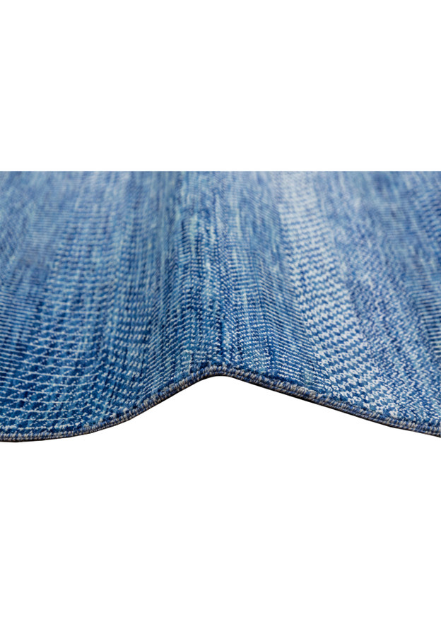 Side angle showing the weave and edge of the large 12x18 blue rug